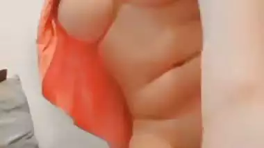 The naked girl fingers her wet pussy during a video call sex